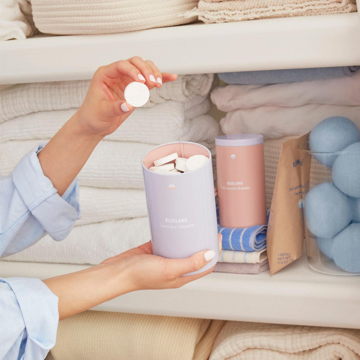 Blueland laundry detergent tablets in front of a linen closet