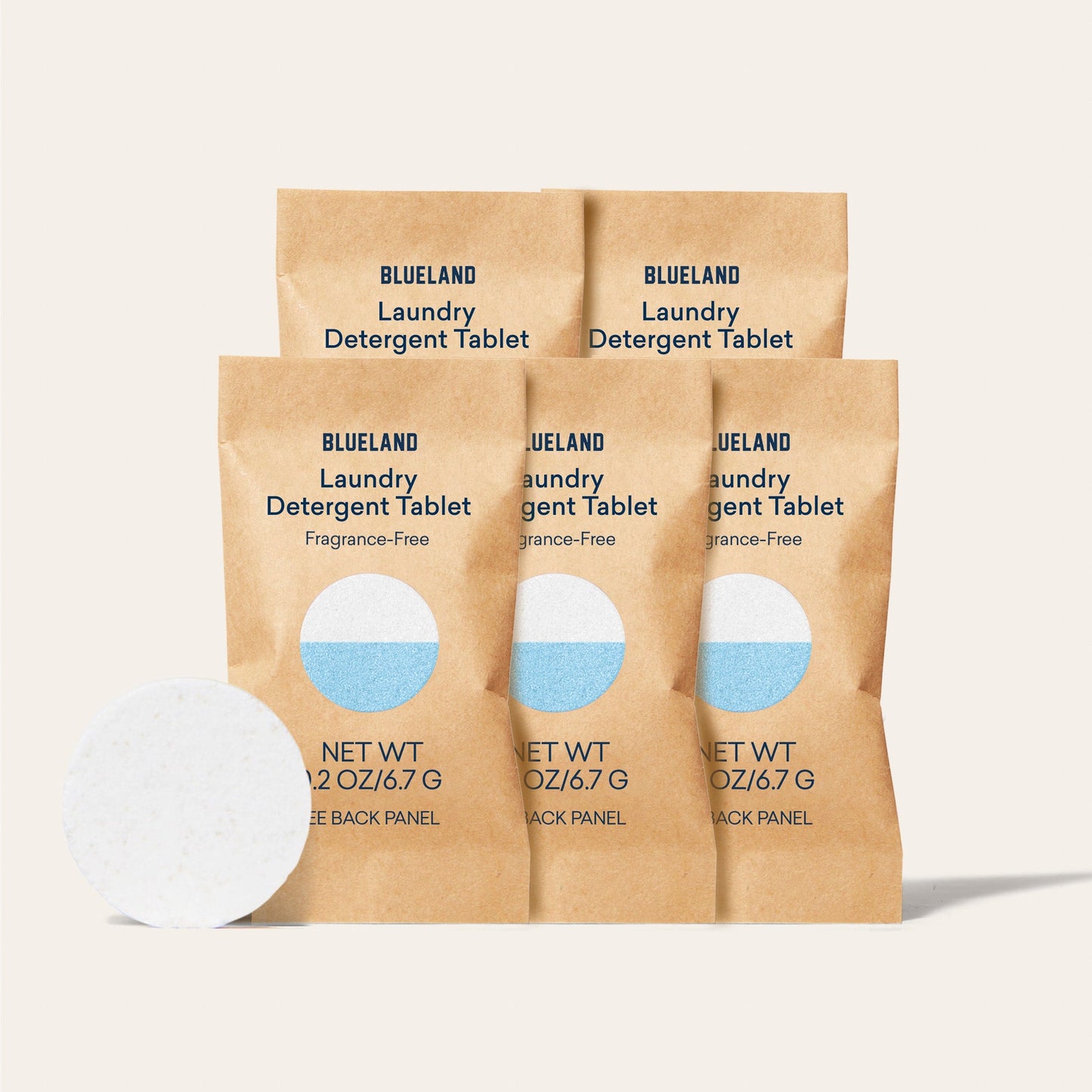 Four brown paper packages of the Laundry Detergent Sample Pack (5 Tablets) are displayed. These powerful, fragrance-free dry-form tablets feature a light blue circle design, ideal for an eco-friendly and efficient wash.