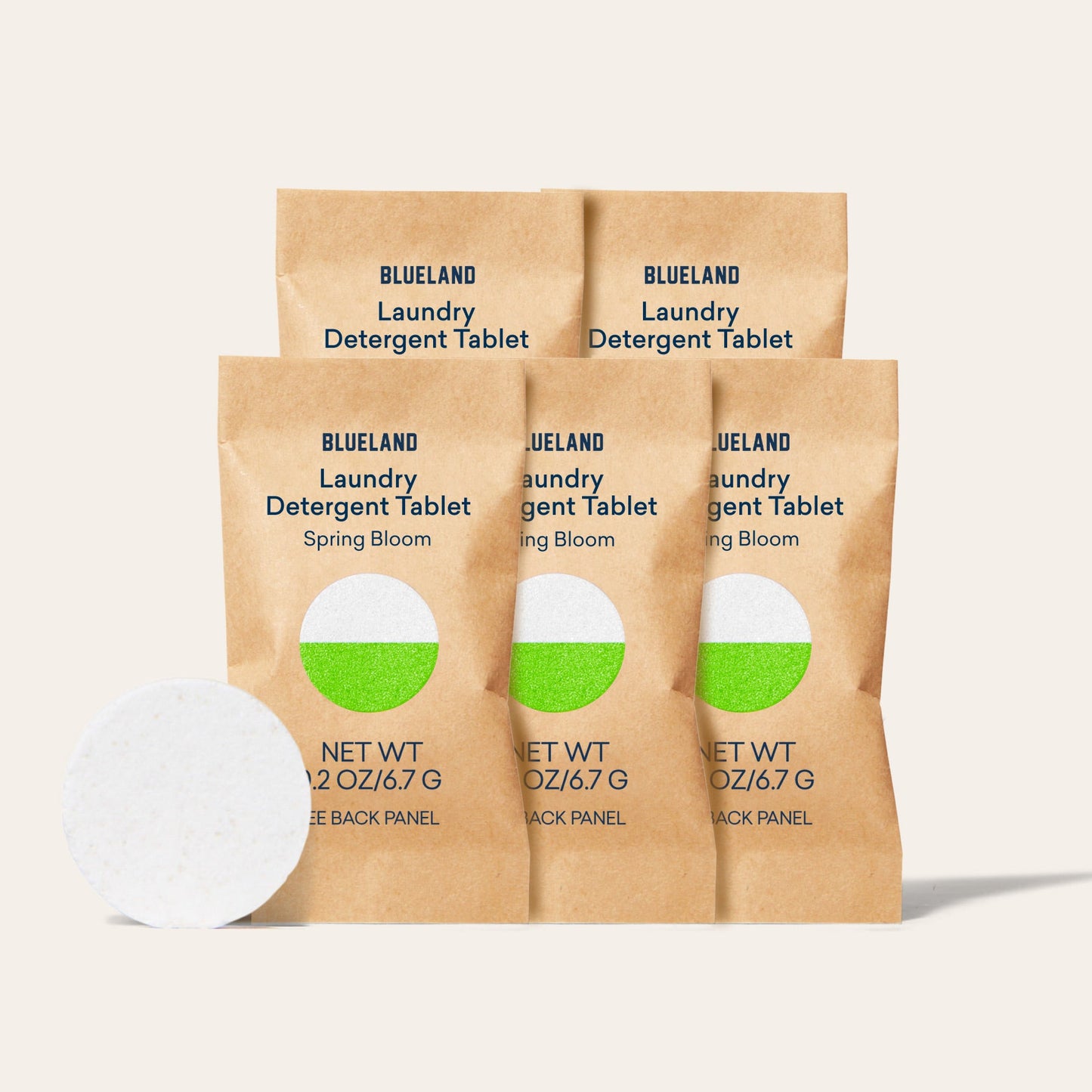 Four brown paper packets labeled Laundry Detergent Sample Pack (5 Tablets) are neatly arranged with a dry-form tablet in front. Each packet specifies Net WT 0.2 oz/6.7 g at the bottom, offering an efficient laundry solution.